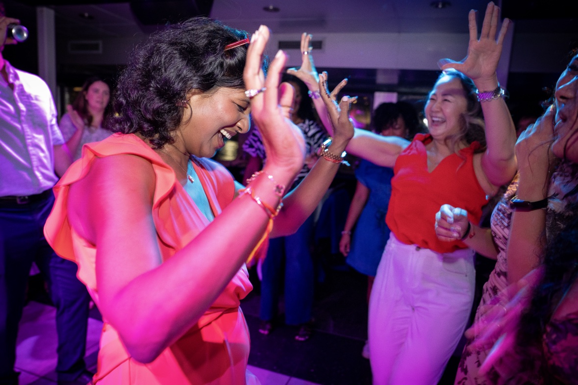 Guests laughing and dancing with their hands up on a Yacht Party dance floor