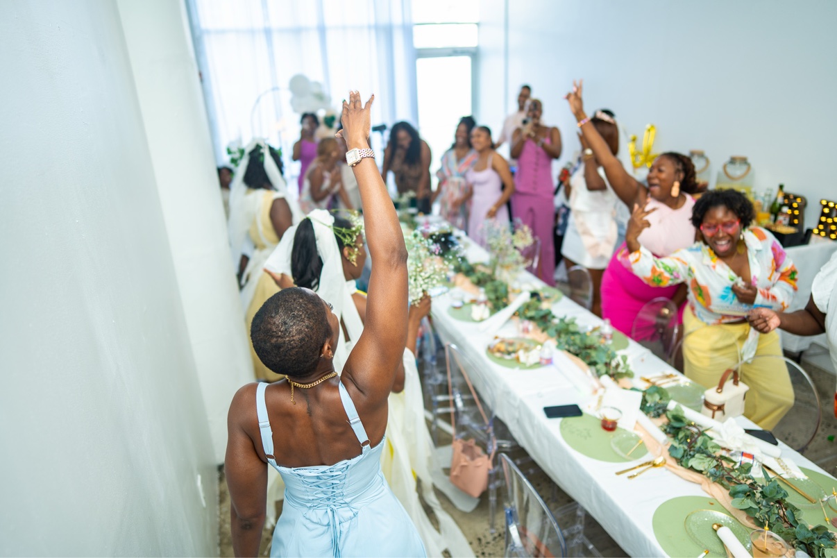 Guests dancing around the bride-to-be at a bridal shower