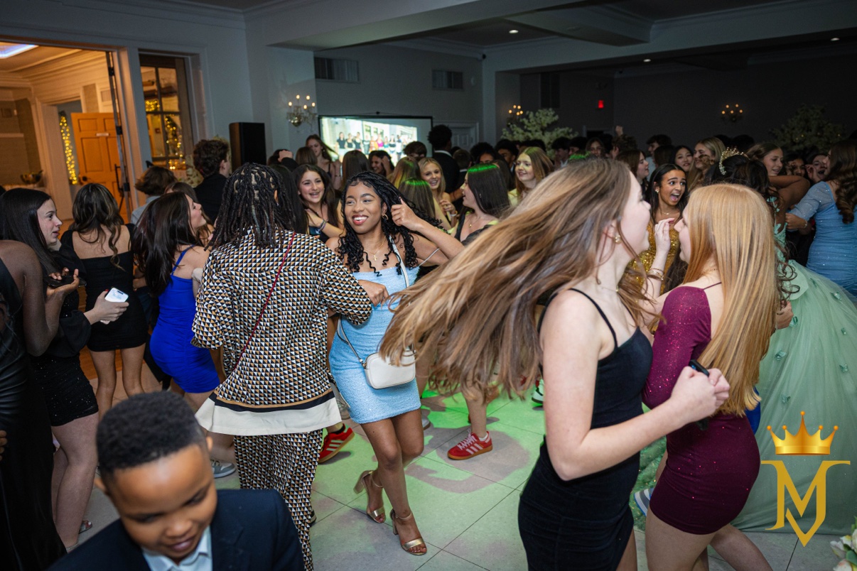 Quinceañera in a mint-green gown and tiara dancing with her guests